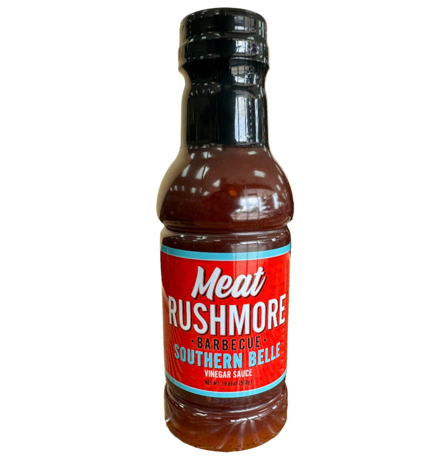 Bottle of Meat Rushmore Barbecue Sauce on a grill