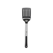 A professional kitchen utensil featuring a dark gray silicone slotted head and a stainless steel handle with a black grip, branded with the 'Hermana' logo.