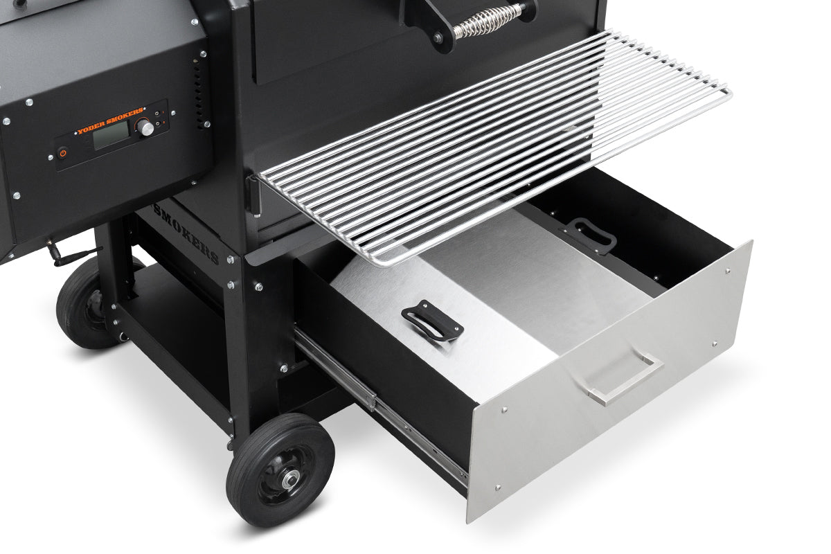 Black barbecue grill with open drawer on a white background